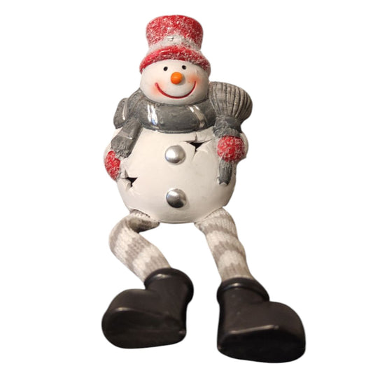 Snowman sitting by the light
