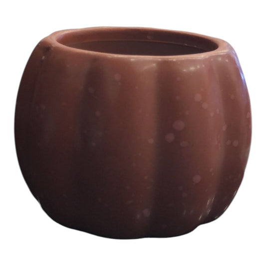 Pumpkin-shaped candle